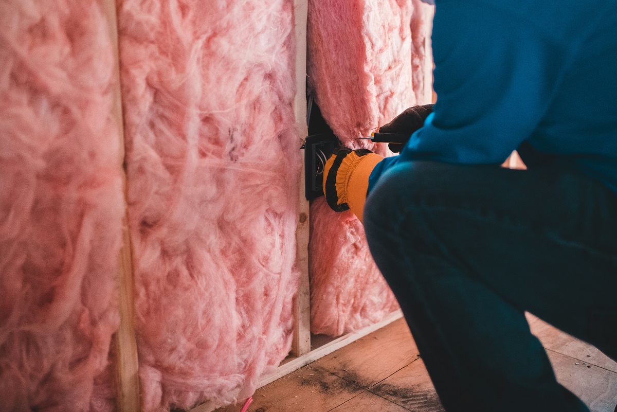 close-up of a man installing insulation